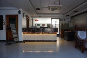 a room with a lobby with a counter in it at Kingscross Residency in Chennai