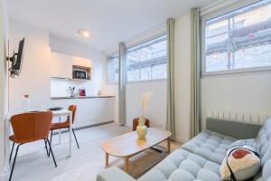 - un salon avec un canapé et une table dans l'établissement Renovated 1 bedroom apartment, à Lille