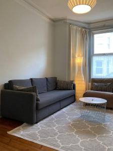 a living room with a couch and a table at The Blue House in Worthing