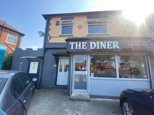 a dinner restaurant with a car parked in front of it at 1 Bedroom flat, Close to All You Need! in Kenton