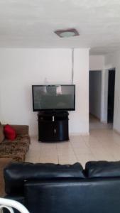 Il comprend un salon doté d'un canapé et d'une télévision à écran plat. dans l'établissement Chácara Nossa Senhora Aparecida, à Ribeirão Pires