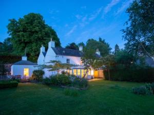 a large white house with a yard at night at 3 Bed in Llangorse BN331 in Cathedine