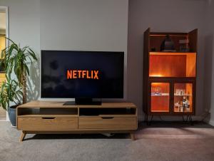 a tv sitting on top of a wooden entertainment center at Moorside Terrace in Guisborough