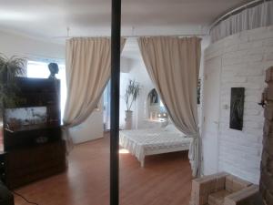 a living room with a bed and a window at Private Apartment For You in Tartu