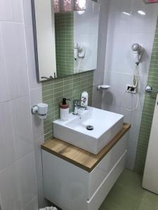 a bathroom with a white sink and a mirror at Busalacchi B&B in Mondello
