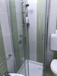 a bathroom with a glass shower with a toilet at Busalacchi B&B in Mondello