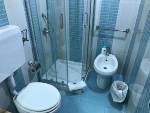 a bathroom with a shower and a toilet and a sink at Busalacchi B&B in Mondello