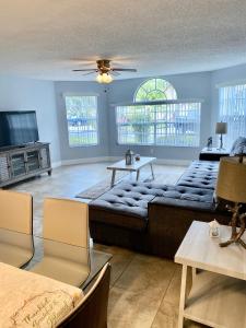 a living room with a couch and a tv at Great Lovely Family Apartment close Disney in Kissimmee