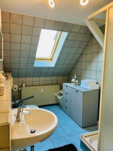 a bathroom with a sink and a skylight at Auszeit in Große Mühle