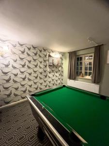 a pool table in a room with a fish mural at The Dawnay Arms in West Heslerton