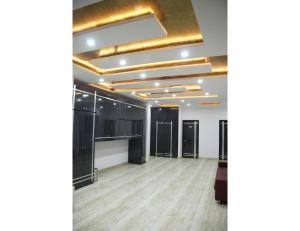 a large room with black and gold ceilings and wooden floors at Hotel Sobti Plaza, Ambala, Haryana in Ambāla