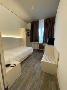 a hotel room with a bed and a desk at Hotel Albatros in Mestre