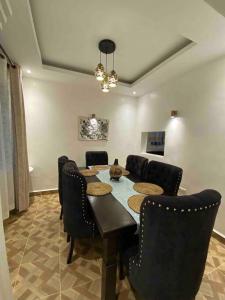 a dining room with a table and chairs at Zen House in Kakamega