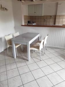 a white table and chairs in a kitchen at Alexandros Studios Apartments in Roda