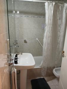 ein Badezimmer mit einer Dusche, einem Waschbecken und einer Badewanne in der Unterkunft "Tu refugio espacioso en el corazón de MENDOZA y el PARQUE" in Mendoza