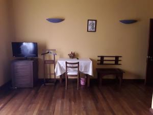 a dining room with a table and a tv at Hotel le colbert in Diego Suarez