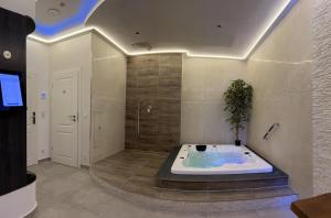 a large bathroom with a jacuzzi tub in a room at me and SPA in Düsseldorf