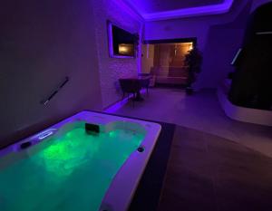 a room with a jacuzzi tub with purple lighting at me and SPA in Düsseldorf