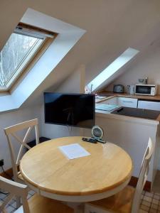 a kitchen with a wooden table in a kitchen with a desk at Top Floor Flat Ceol Na Mara (Music of the Sea) in Rosemarkie