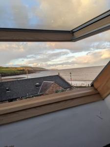 a view of the ocean from a window at Top Floor Flat Ceol Na Mara (Music of the Sea) in Rosemarkie