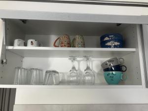 a shelf with glass vases and other items on it at maison entre plage marais et forêt in Olonne-sur-Mer