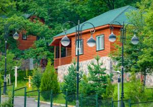 a house with a fence in front of it at Deluxe Park Qusar Resort & Spa Hotel in Qusar