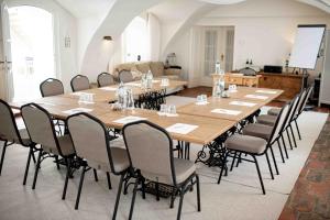 a conference room with a large wooden table and chairs at Großkandlerhaus in Unterdambach