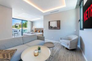 a living room with a couch and a table at 797 HOLIDAY RENTALS - Lujosa y moderna villa en Puerto marina in Benalmadena Costa