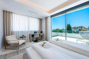 a bedroom with two beds and a large window at 797 HOLIDAY RENTALS - Lujosa y moderna villa en Puerto marina in Benalmadena Costa +54 photos