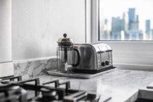 a toaster sitting on top of a kitchen counter at Stunning Massive Bedroom +Direct Thames River View in London