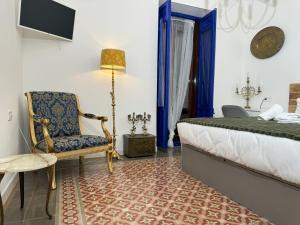 a bedroom with a bed and a chair and a lamp at Castaños 4 in Alicante