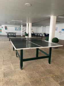 a ping pong table in the middle of a room at Beachfront 3-bedroom apartment in Calafell +37 photos