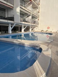 a swimming pool in the middle of a building at Beachfront 3-bedroom apartment in Calafell