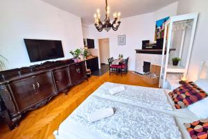 a living room with a bed and a television at TRUE ZAGREB centrally located & spacious apartment in Zagreb
