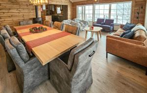a dining room with a wooden table and chairs at Cozy Home In Treungen in Treungen