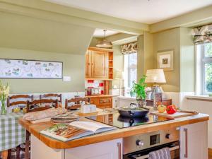 a kitchen with a island with a counter top at 4 Bed in Huntly 88855 in Inverurie