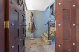 a hallway with a staircase with a dress on the wall at Coco Villa - Central Mediterranean-style Pool Oasis in Port Douglas