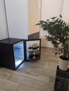 a refrigerator with bottles of wine in a room at Villa Iva in Rakovica