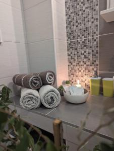 a pile of towels on a table in a bathroom at Villa Iva in Rakovica