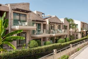 una fila de casas con plantas verdes en Airis Boutique Hotel & Suites - For adults only en Kato Daratso