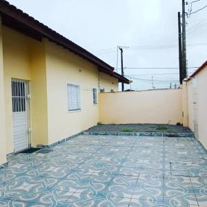 a house with a tile floor in front of a building at Casa De Hóspede in Itu