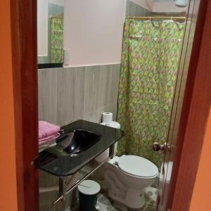 a bathroom with a sink and a toilet at Centro Vacacional RECREASANA in Puerto López