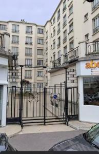 a black gate in front of a building at CityStay-Confort- 5 min Metro - in Boulogne-Billancourt