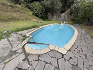 a swimming pool with a metal rail around it at Albergue de Cabañes in Cabañes