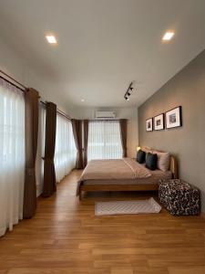 - une chambre avec un grand lit et des rideaux dans l'établissement AnnaHome89/63@Latkrabang, à Ban Khlong Prawet