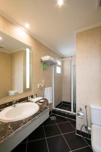 a bathroom with a sink and a shower at Swiss Inn Resort Hurghada in Hurghada