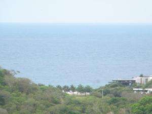 a view of the ocean from the top of a hill at Centro Vacacional RECREASANA in Puerto López