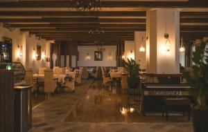 a restaurant with tables and chairs in a room at Hotel Marshal in Nikšić