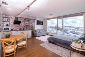 a bedroom with a bed and a table and a kitchen at Revalia Fahle Airport Bus-Station Studio in Tallinn