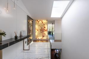 a hallway with a glass door with a painting on the wall at Golfe Villa ' Paraíso de Luxo ' Piscina Aquecida in Ponte de Lima